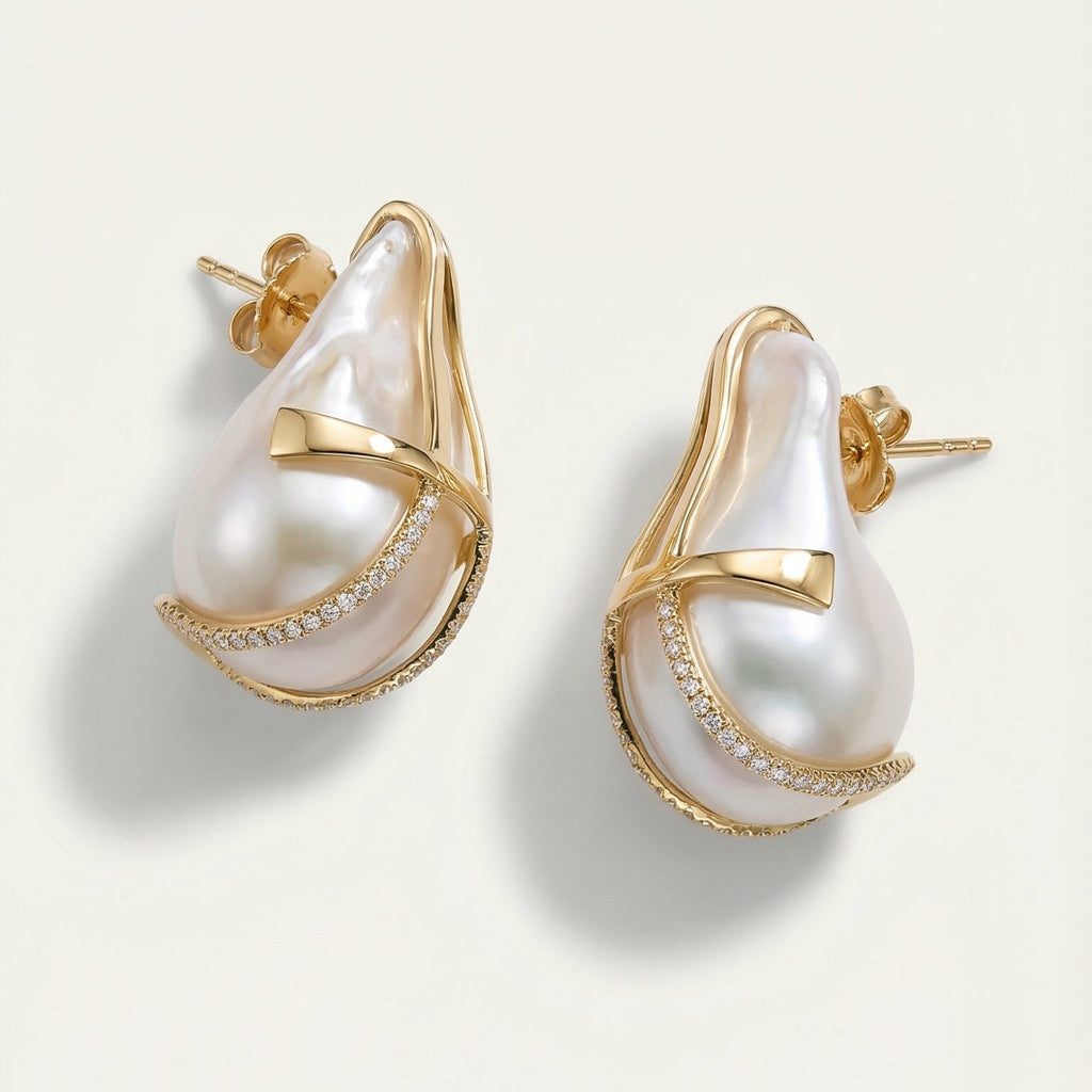 Gold and pearl earrings on a light beige background