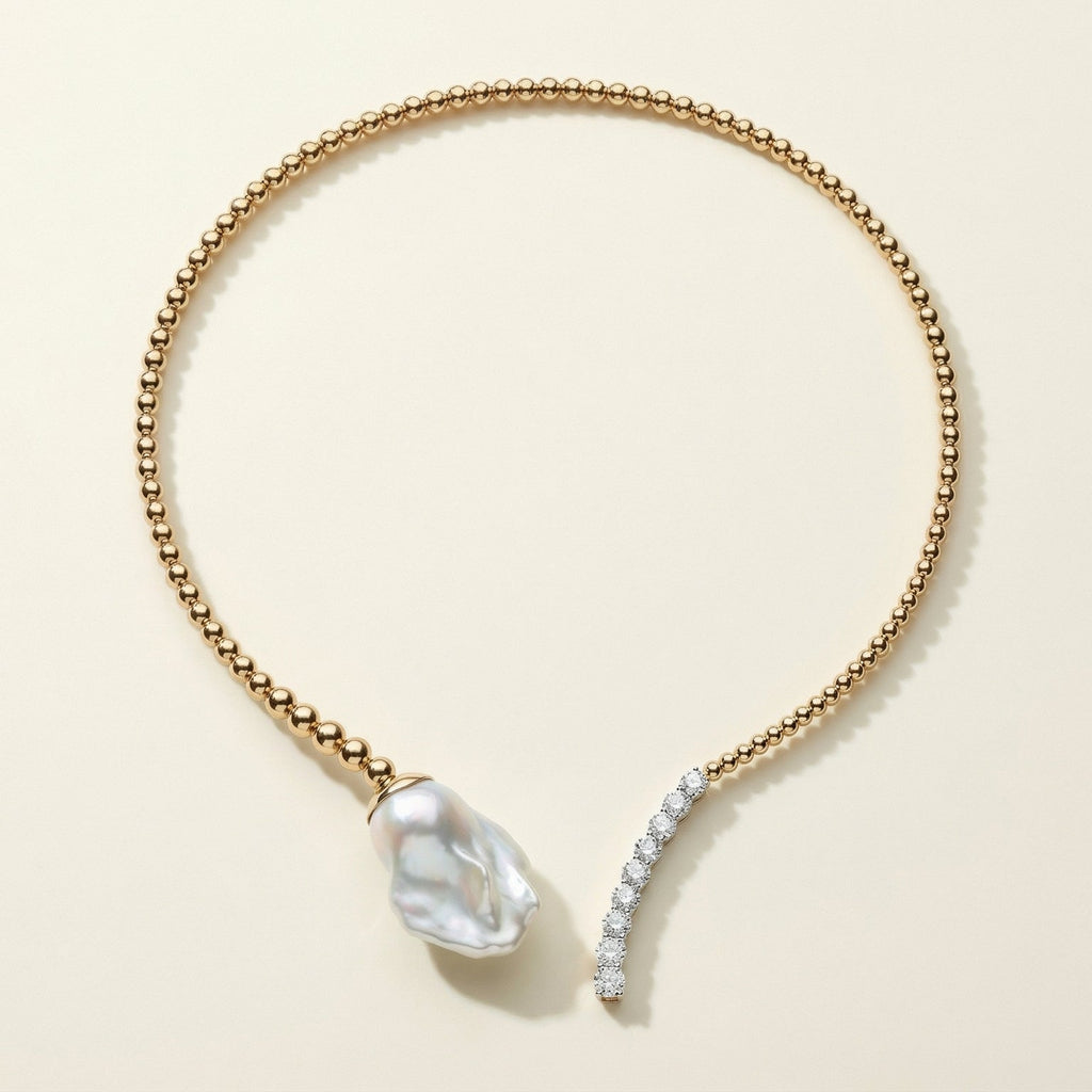 Gold necklace with a pearl and diamond pendant on a beige background