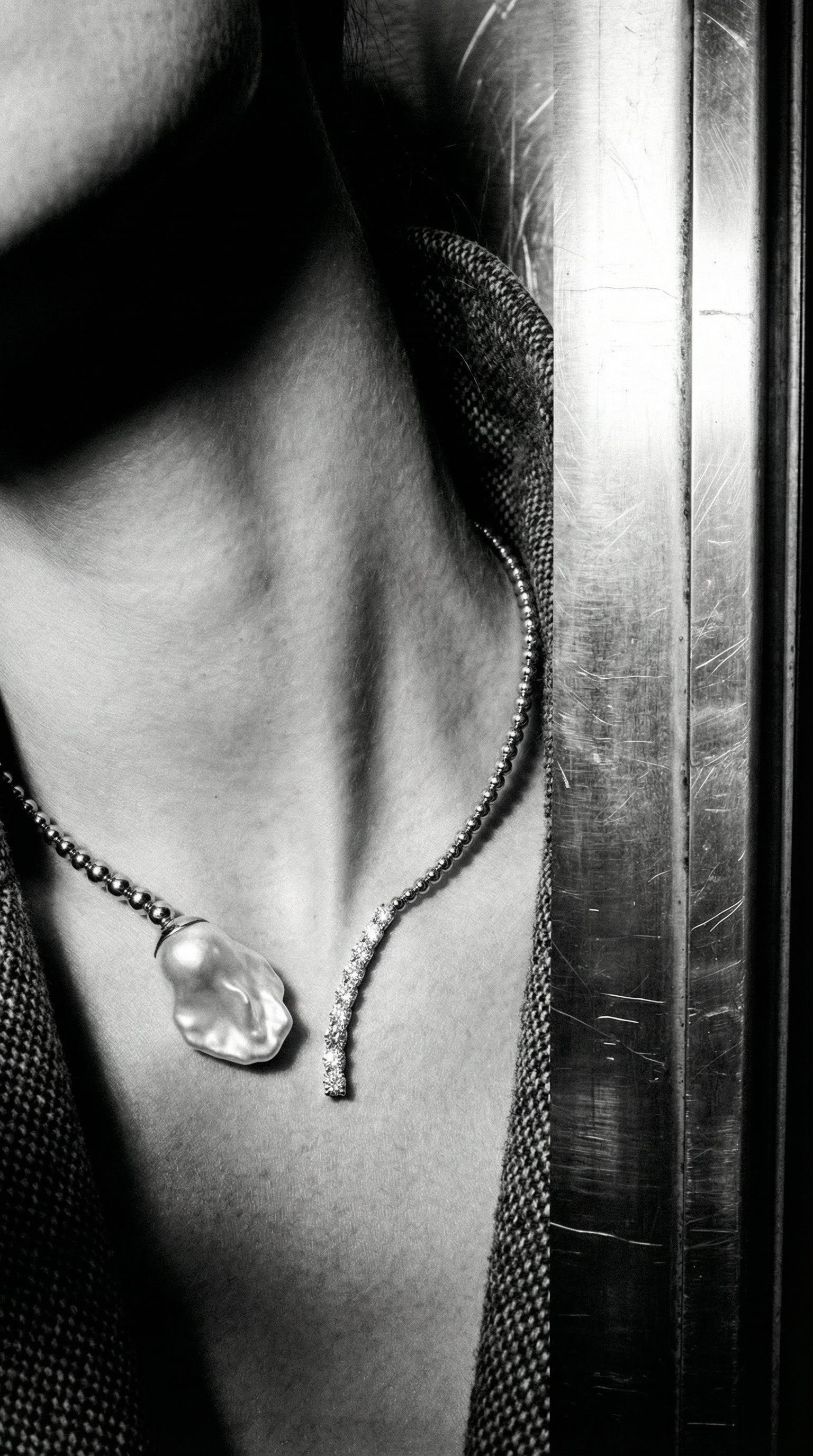 Close-up of a necklace with a pendant on a textured surface