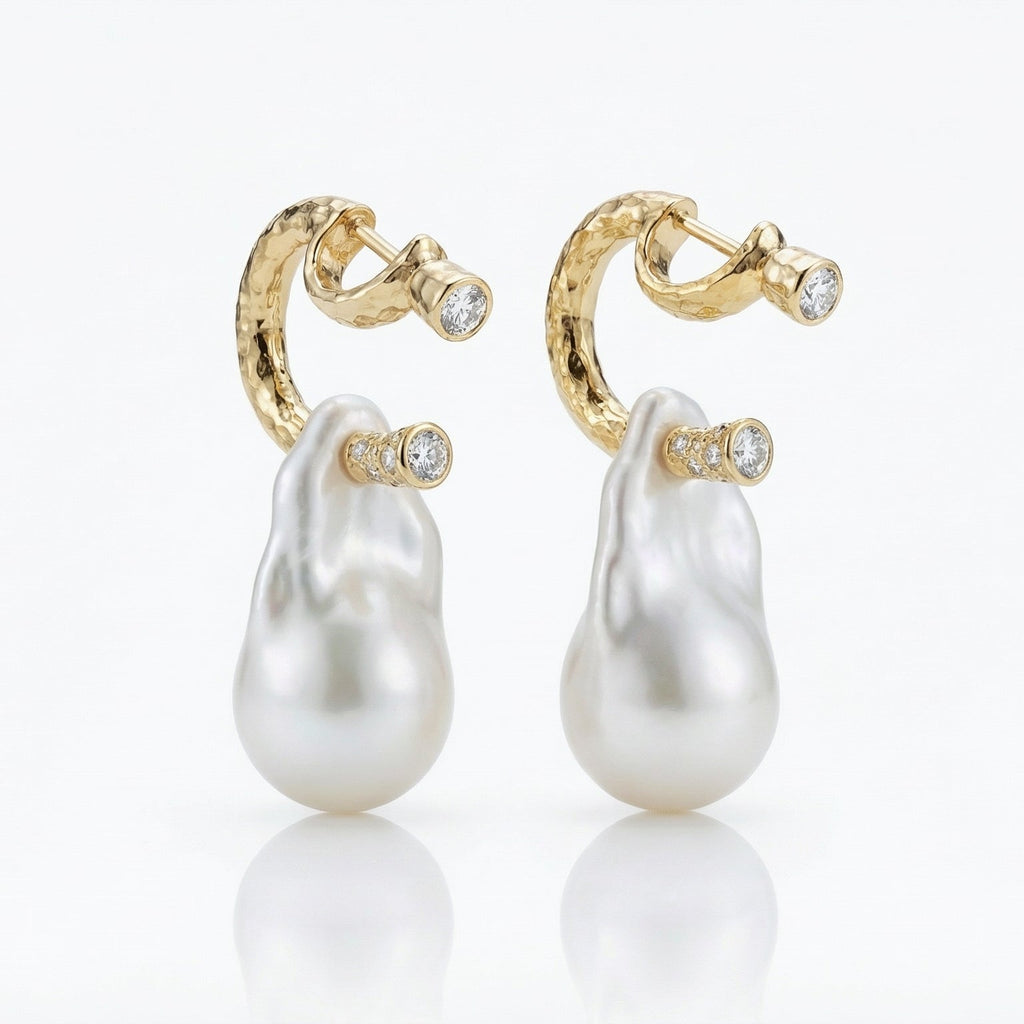 Pair of pearl earrings with gold hooks on a white background