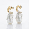 Pearl earrings with gold accents on a white background
